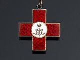 a close up of a cross with a red and white cross on it