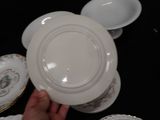 a person holding a white plate in their hand