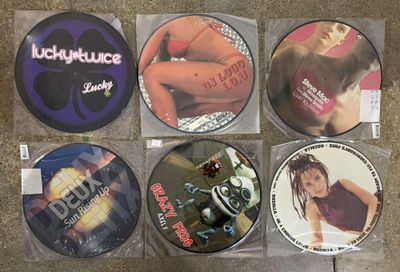 six cd ' s in plastic bags sitting on a counter top