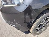 a close up of a car ' s front bumper with a broken tire