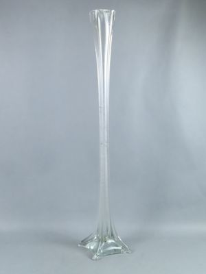 a tall glass vase that is sitting on a table