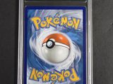 a close up of a pokemon card on a black surface