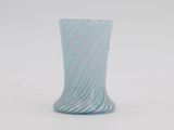 a blue and white vase sitting on a white surface
