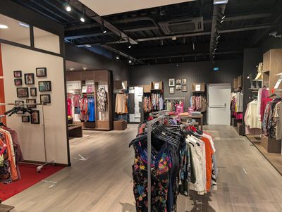 an image of a clothing store with clothes on display