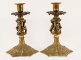 pair of antique brass candlesticks with cherenshes and cherenshes on them