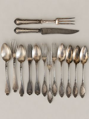 a lot of silver spoons and forks on the table