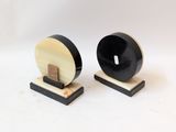 pair of black and white wooden bookends with a wooden base