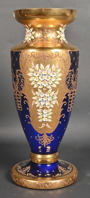 a blue and gold vase sitting on a table