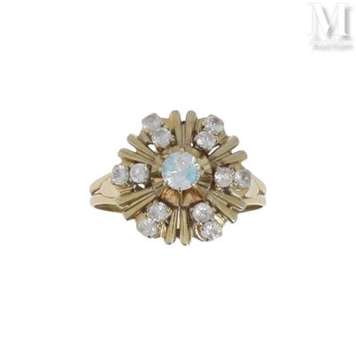 an image of a gold ring with a blue stone surrounded by diamonds