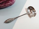 a spoon that is sitting on a table next to an eggplant