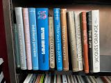 many books that are on a shelf in a book case
