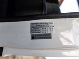 a close up of a car ' s rear view mirror with a sticker on it