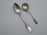 two spoons that are sitting next to each other on a table