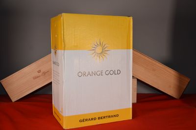 a box of orange gold sitting on a red cloth