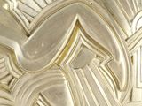 a close up of a gold plate with a design on it