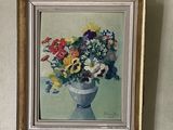 a painting of flowers in a vase hanging on the wall
