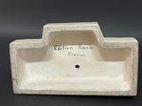a white ceramic ashtray with a writing on it
