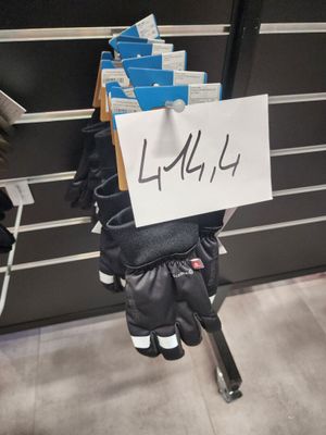 a sign on the back of a pair of gloves
