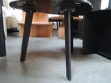 a black table with two black chairs and a black chair
