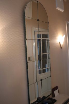 a mirror on the wall above a desk in a room