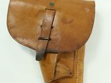 a brown leather holster with a belt on a white background