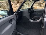 the door of a car is open with the driver ' s door open