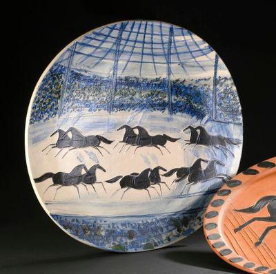 a plate with a picture of horses running on it