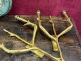 a wooden table topped with a bunch of brass utensils