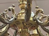 a gold chandelier hanging from the ceiling in a room