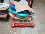 a pile of cds on a pallet next to a suitcase