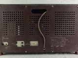 a close up of a brown electronic device on a white surface