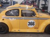a yellow car that is parked in a garage