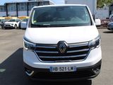 la camionnette blanche est garée dans un parking avec d'autres voitures