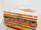 books stacked on top of each other on a white table