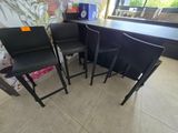 three black chairs and a table in a room