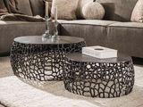 two tables that are sitting on a rug in a living room
