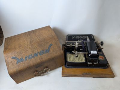 an old typewriter sitting next to a wooden box