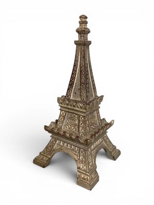 the eiffel tower is made out of metal and has intricate carvings