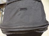 a black suitcase sitting on top of a metal cart