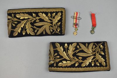 pair of black and gold embroidered purses with gold leaf design