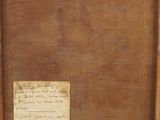 an old picture of a wooden frame with a piece of paper on it