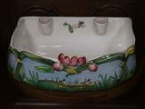a picture of a ceramic sink with flowers painted on it