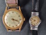 two watches sitting next to each other on a table