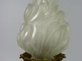 a white and gold vase with a white flower on it