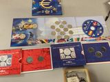 a lot of different coins and coins on the table