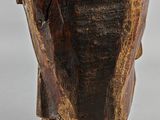 an old wooden statue of a man with a hat on his head
