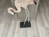 a statue of a flamingo standing on top of a kitchen island