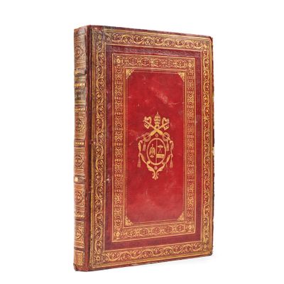 an old red book with a gold design on the cover