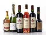 several bottles of wine are lined up on a white surface