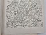 an open book with a map of a town on it